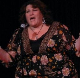 Kelly performing stand-up.